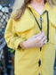 Person wearing a yellow jacket with a blurred background