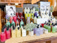 Assorted bottles of hand soap and lotions on a wooden table with a blurred background